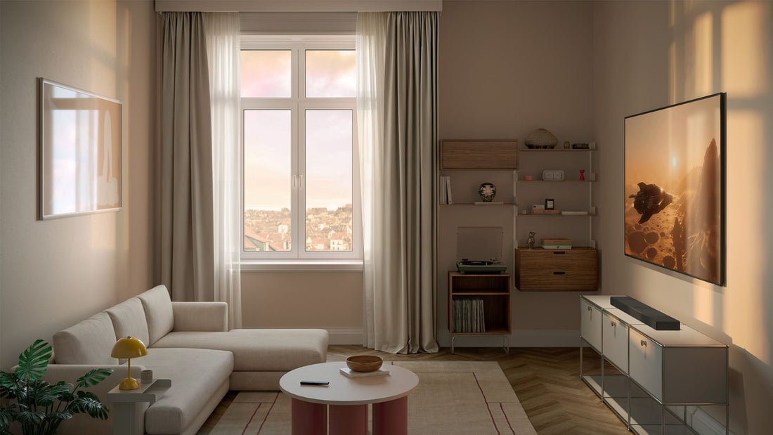 A living room setup with a comfortable sofa, a stylish coffee table, and a television beneath there's KEF XIO Sound bar