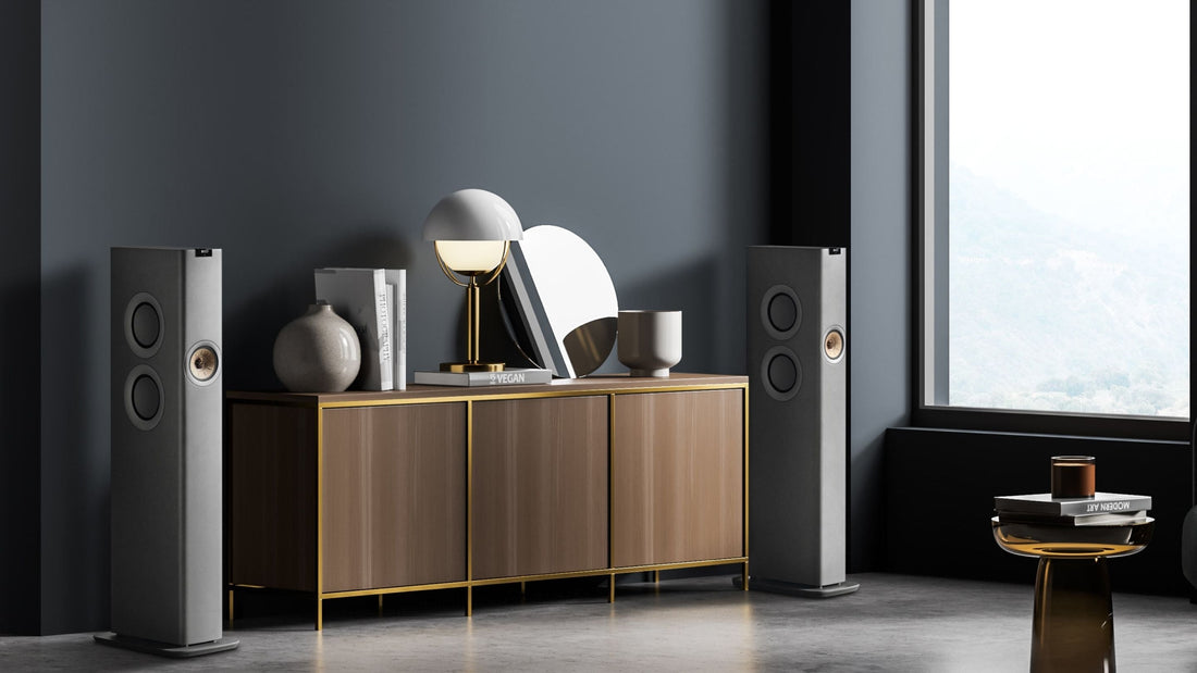 Modern interior with a wooden sideboard, decorative items, and KEF LS60 speakers.