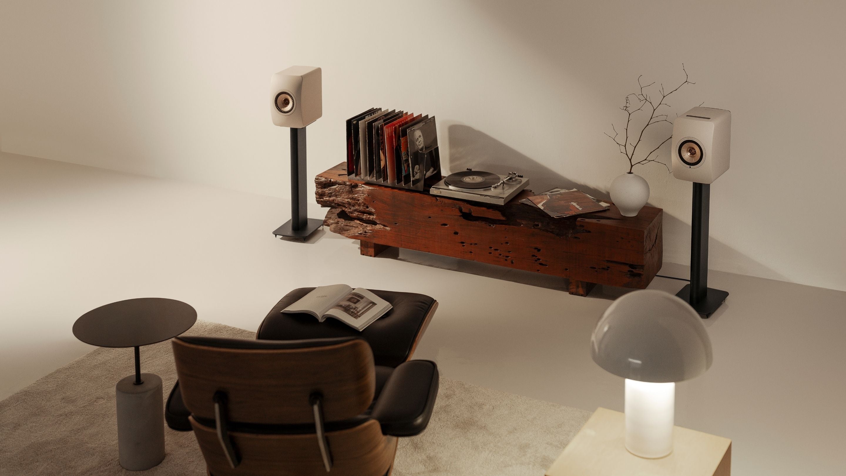 Modern living room with a chair, table,  decorative items & LS5O Wireless II mounted to a S2 Floor stand