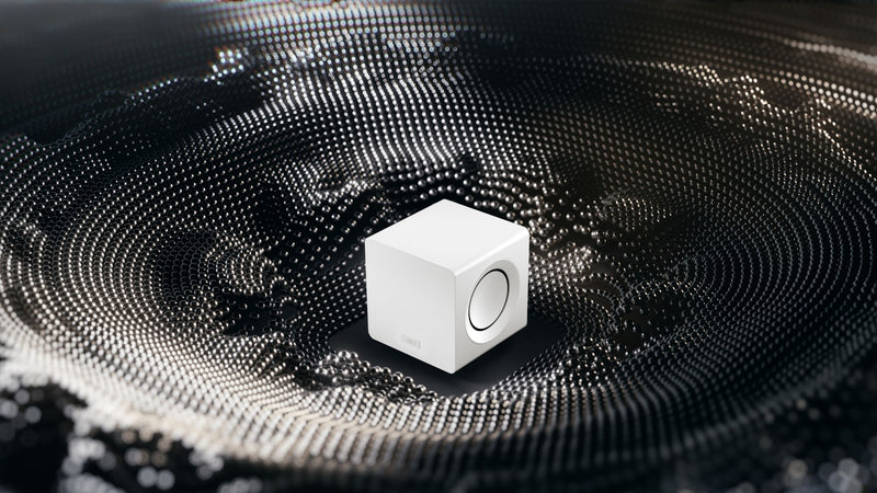 KEF KC92 subwoofer placed in the middle of dark grey absorption metarial